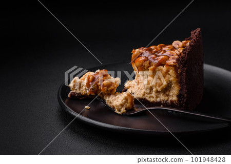 Delicious fresh cheesecake cake or snickers with cream and nuts 101948428