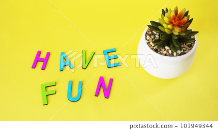 Have fun in colorful toy letters on yellow background with cactus 101949344