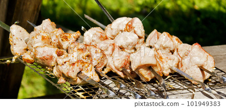 Shish kebab of the pork with the mix of spices on skewers on the old grill Shish kebab of the pork with the mix of spices on skewers on the old grill 101949383