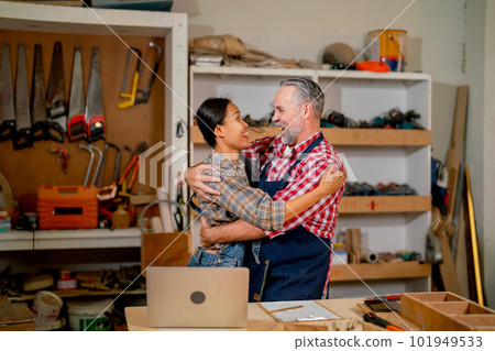 Carpenter lovers stand and hug closely together to celebrate the successful of work in workplace Carpenter lovers stand and hug closely together to celebrate the successful of work in workplace 101949533