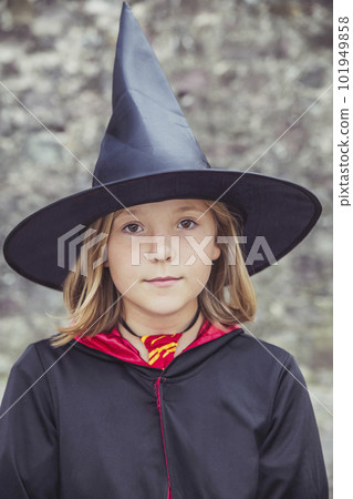 young fair-haired sorceress in mantle and hat 101949858