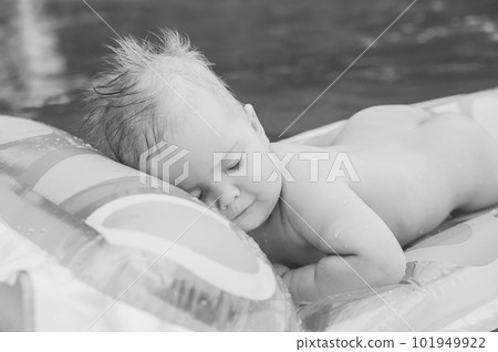 beautiful baby floating on air mattress on the river 101949922