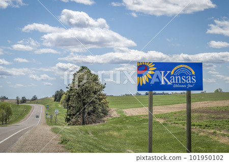 Kansas welcomes you - welcome roadside sign with a popular Latin phrase ad astra per aspera (through hardships to the stars), driving and travel concept 101950102