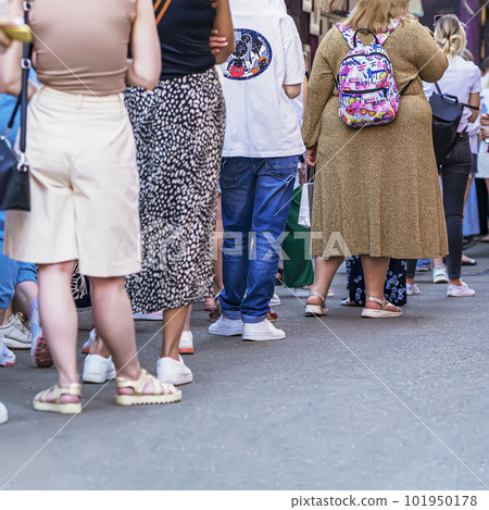 Group of young people standing in queue, rear view, summer, selective focus 101950178