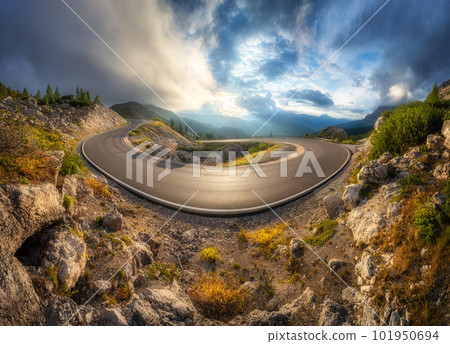 Mountain road at colorful sunset in summer. Curved roadway Mountain road at colorful sunset in summer. Curved roadway 101950694