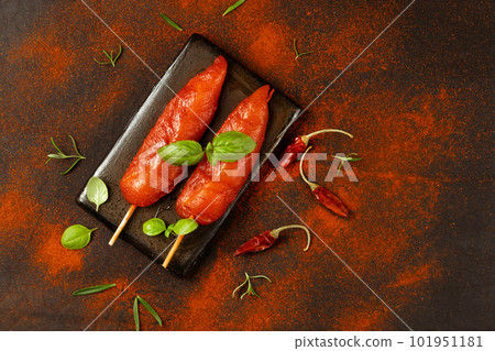 Fresh raw marinated chicken meat skewers iner fillet with fresh herbs on a black background.Top view.Copy space.Chicken fillet inner skewers.Food concept.Food for retail.Ogranic food,healthy eating. Fresh raw marinated chicken meat skewers iner fillet with fresh herbs on a black background.Top view.Copy space.Chicken fillet inner skewers.Food concept.Food for retail.Ogranic food,healthy eating. 101951181