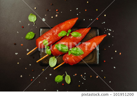 Fresh raw marinated chicken meat skewers iner fillet on a black background.Top view.Copy space. Fresh raw marinated chicken meat skewers iner fillet on a black background.Top view.Copy space. 101951200