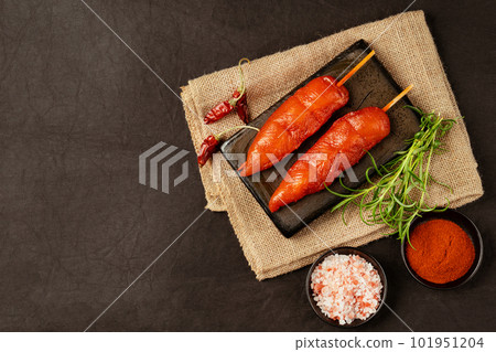 Ogranic food,healthy eating.Fresh raw marinated chicken meat skewers iner fillet with fresh herbs on a black background.Top view.Copy space.Chicken fillet inner skewers.Food concept.Food for retail. 101951204