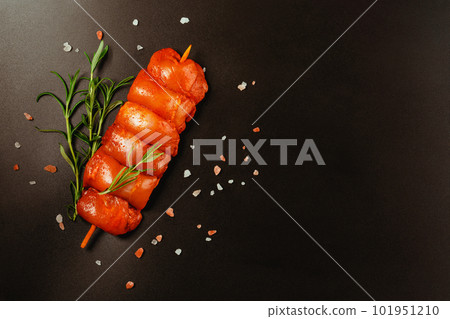 Chicken Skewers meat.Close up of chicken meat.Procurement for designers.Fresh raw marinated skinless chicken leg meat skewers with fresh herbs on a black background.Top view.Copy space. Chicken Skewers meat.Close up of chicken meat.Procurement for designers.Fresh raw marinated skinless chicken leg meat skewers with fresh herbs on a black background.Top view.Copy space. 101951210