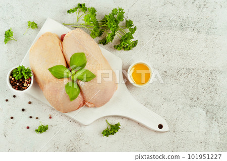 Raw fresh chicken leg meat with skin and with fresh herbs on a gray background.Copy space.Food for retail.Procurement for designers.Ogranic food,healthy eating.Food concept.Top view.Chicken leg meat. Raw fresh chicken leg meat with skin and with fresh herbs on a gray background.Copy space.Food for retail.Procurement for designers.Ogranic food,healthy eating.Food concept.Top view.Chicken leg meat. 101951227