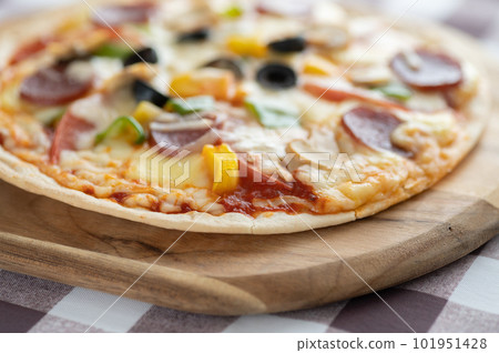 Milanese-style pizza with a thin crust Milanese-style pizza with a thin crust 101951428