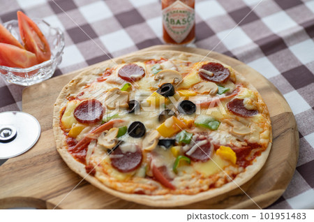 Milanese-style pizza with a thin crust 101951483