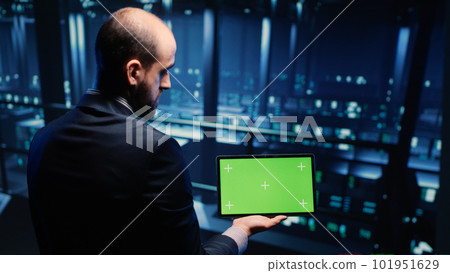 IT administrator running greenscreen display on tablet, using cloud computing in render farm. System technician working with isolated template and chroma key copyspace, artificial intelligence. IT administrator running greenscreen display on tablet, using cloud computing in render farm. System technician working with isolated template and chroma key copyspace, artificial intelligence. 101951629