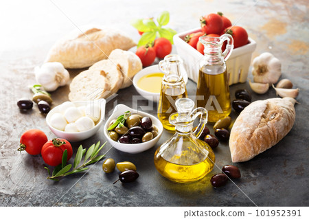 Olive oil in vintage bottles and italian cuisine ingredients Olive oil in vintage bottles and italian cuisine ingredients 101952391