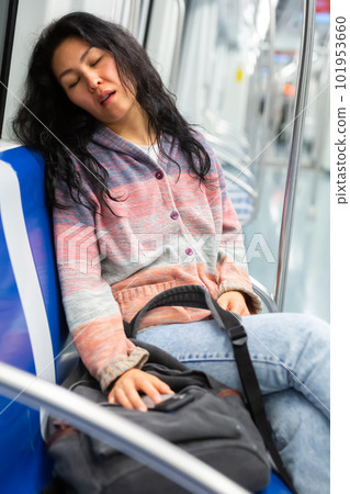 Young woman passenger sleeping in subway car Young woman passenger sleeping in subway car 101953660