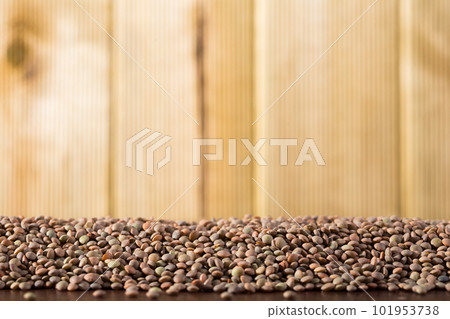 Background with raw lentil grains on wooden surface, nutritious food Background with raw lentil grains on wooden surface, nutritious food 101953738
