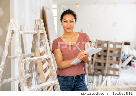 Portrait of positive woman construction manager with documents 101953911