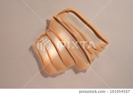 Foundation swatch with spf on a beige background. Foundation swatch with spf on a beige background. 101954587