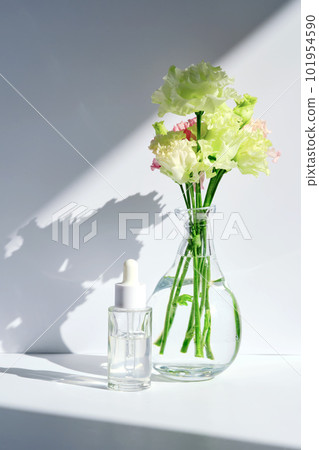 Serum with a dropper with spring flowers. Serum with a dropper with spring flowers. 101954590