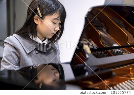 Junior high school student playing the piano 6th grade 101955774