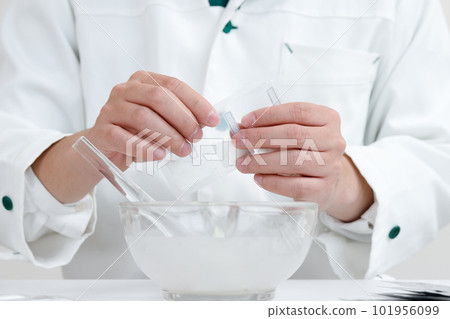 pharmacist with crushing instructions. A hand mixing medicine in a pestle 101956099