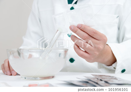 pharmacist with crushing instructions. A hand mixing medicine in a pestle pharmacist with crushing instructions. A hand mixing medicine in a pestle 101956101