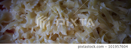 Yummy macaroni bow or farfalle pasta with grated cheese Yummy macaroni bow or farfalle pasta with grated cheese 101957604