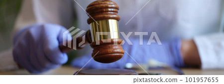 Female doctor with judge gavel and medical stethoscope Female doctor with judge gavel and medical stethoscope 101957655