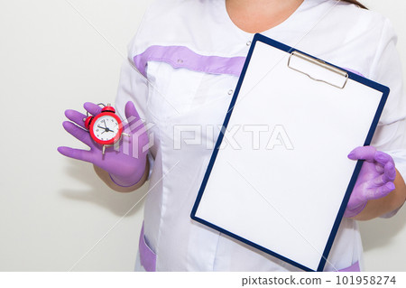 A woman points with a finger at a tablet for paper in her hands A woman points with a finger at a tablet for paper in her hands 101958274