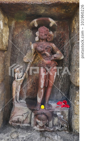 Katayani Images on exterior niches of the 2m high circular temple wall. Each holding a blade in hand and a severed head at the base. Yogini Temple, Hirapur, Bhubaneshwar, Odisha, India. 101960226