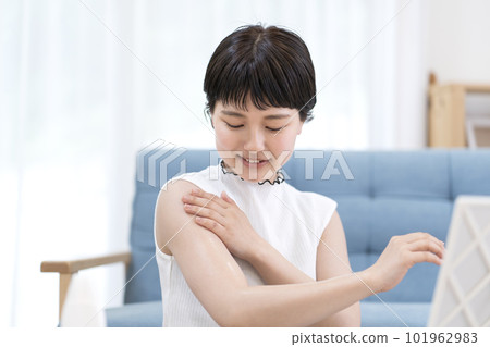 Young woman painting sunscreen Young woman painting sunscreen 101962983