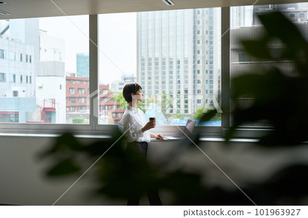 A woman looking out the window 101963927