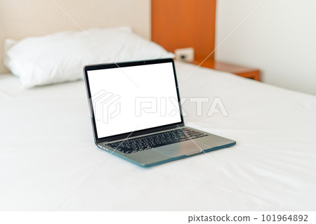 Laptop on empty bed,Caucasian woman laying on bed using laptop Laptop on empty bed,Caucasian woman laying on bed using laptop 101964892