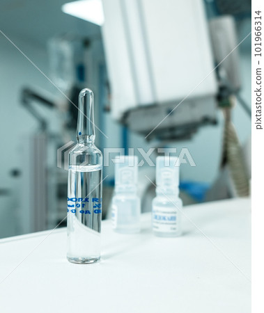 Glass ampoule with medicine on the table in the operating room.  101966314