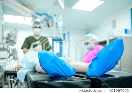 Selective focus on the foot of a person lying on the operating table.  101967095