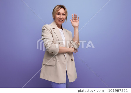 positive blond young business woman in jacket smiling on studio background positive blond young business woman in jacket smiling on studio background 101967231