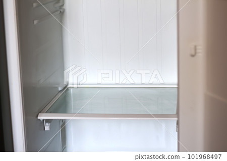 Empty open fridge with shelves, refrigerator. Inside of an empty white fridge. Out of focus Empty open fridge with shelves, refrigerator. Inside of an empty white fridge. Out of focus 101968497