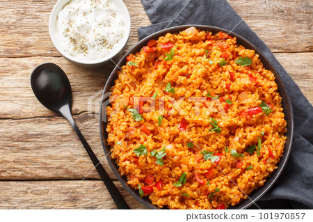 Bulgur Pilaf is a Middle Eastern dish made with vegetables and spices close-up on a plate. Horizontal top view Bulgur Pilaf is a Middle Eastern dish made with vegetables and spices close-up on a plate. Horizontal top view 101970857