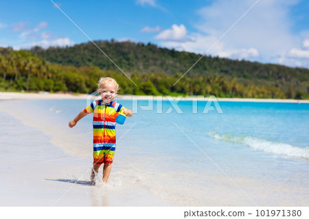 Kids play on tropical beach. Sand and water toy. Kids play on tropical beach. Sand and water toy. 101971380
