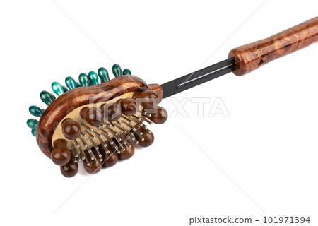 Massage brush for the body with wooden and metal rows of teeth on a white background. 101971394