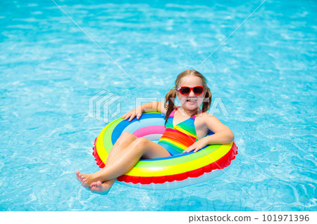 Child in swimming pool on toy ring. Kids swim. 101971396