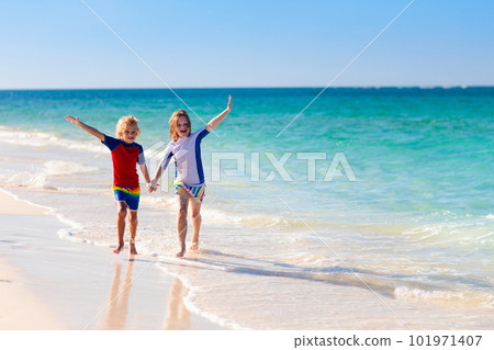 Kids playing on beach. Children play at sea. 101971407