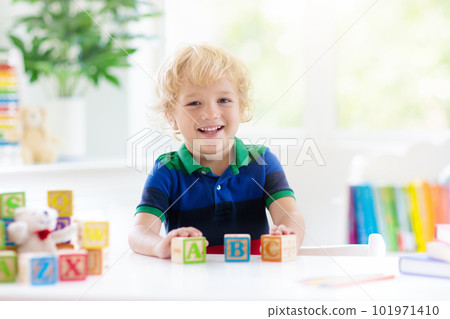 Child learning letters. Kid with wooden abc blocks 101971410