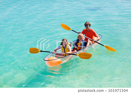 Kids kayaking in ocean. Family in kayak in tropical sea Kids kayaking in ocean. Family in kayak in tropical sea 101971504