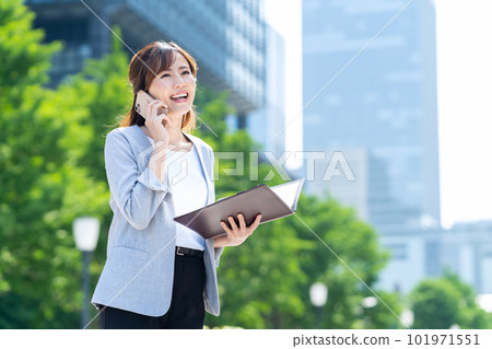 Young businesswoman using smartphone in office district 101971551