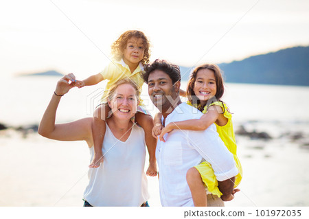 Family walking on tropical beach. Family walking on tropical beach. 101972035