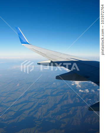 View from the window of the plane, clouds and blue sky 101972764