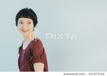 Middle-aged woman with very short hair Middle-aged woman with very short hair 101973548