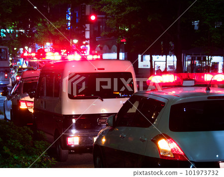 A police car with a siren lamp lit, a crime scene at night A police car with a siren lamp lit, a crime scene at night 101973732