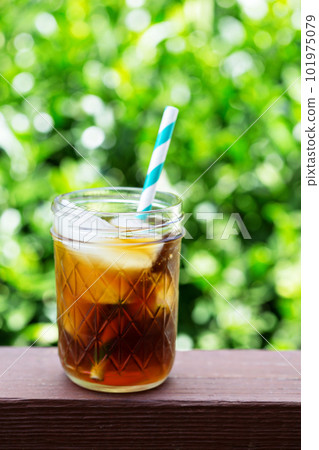 Iced coffee in mason jars outdoors 101975079